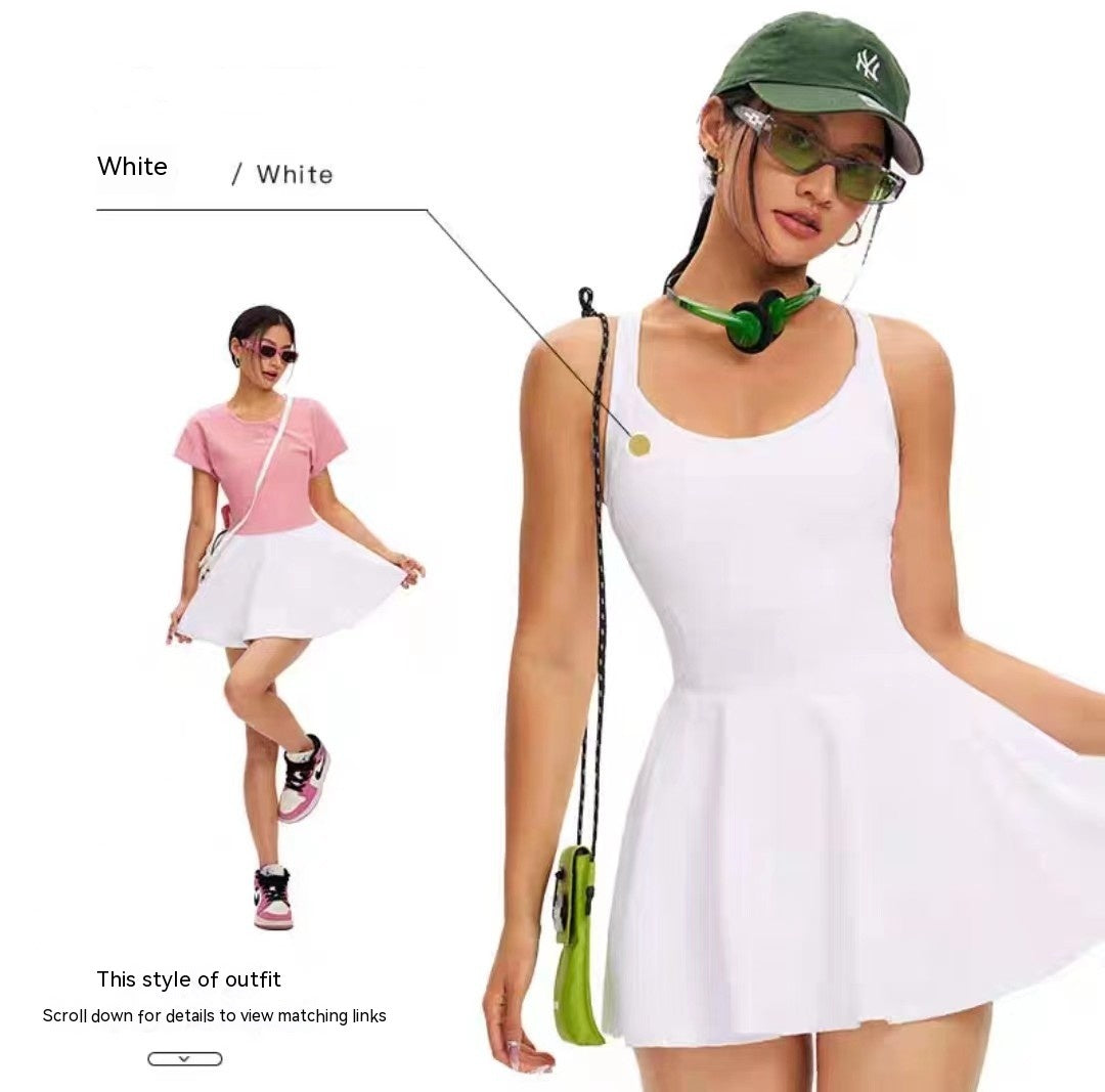 Woman wearing a white dress with a green cap and sunglasses, standing against a white background.