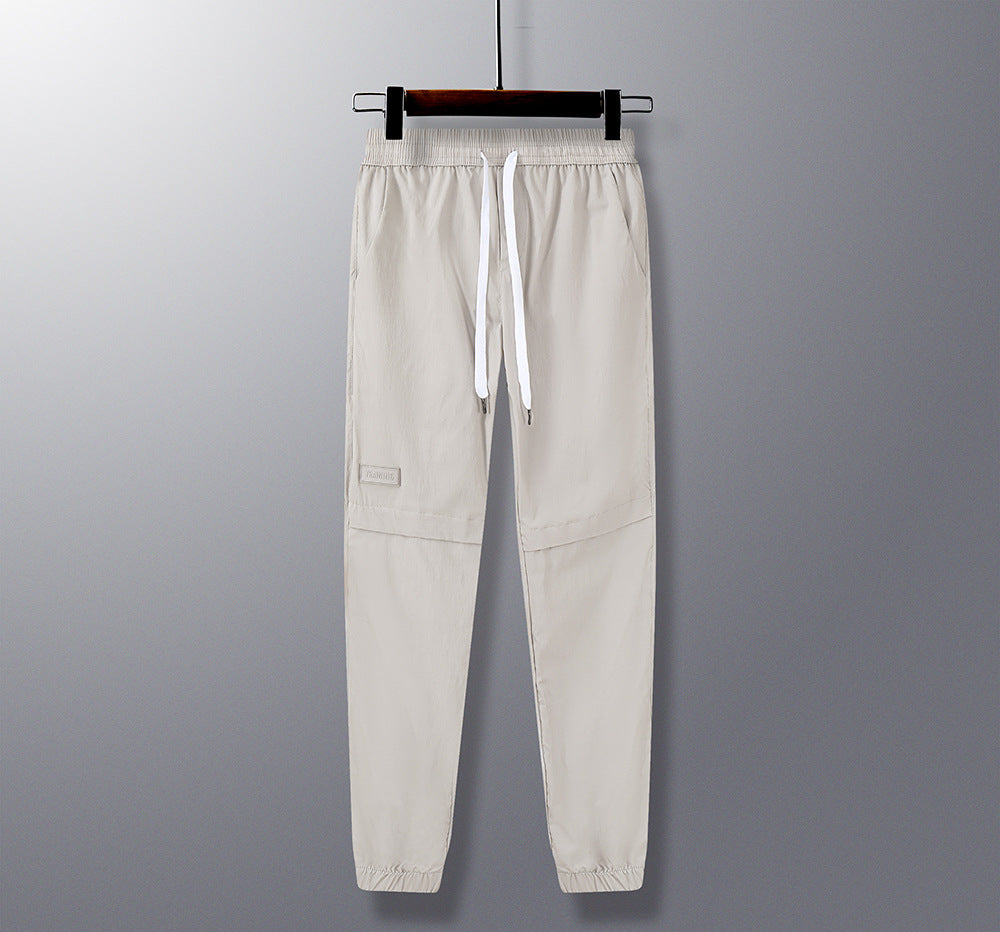 Beige pants with a drawstring on a gray background