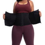 Person wearing a black waist trainer with a plain background