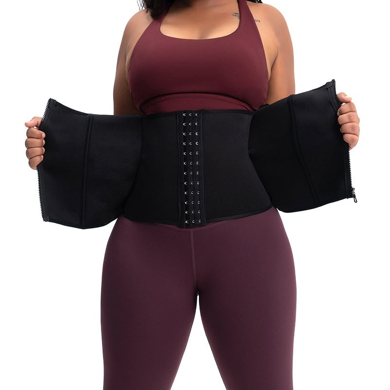 Person wearing a black waist trainer with a plain background