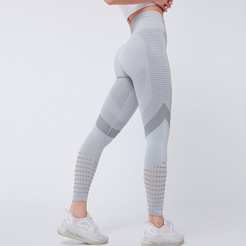 Light gray leggings with geometric patterns worn by a person on a white background