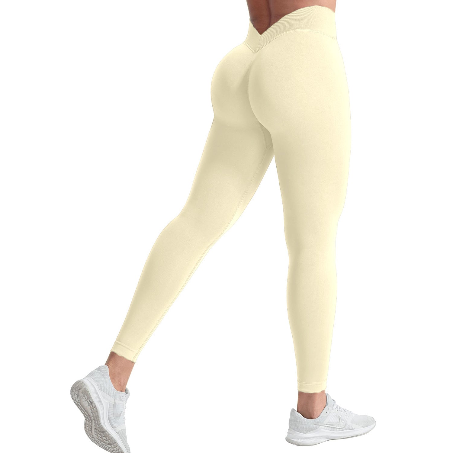 Yellow leggings worn by a person on a white background
