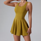 Yellow dress worn by a model on a gray background