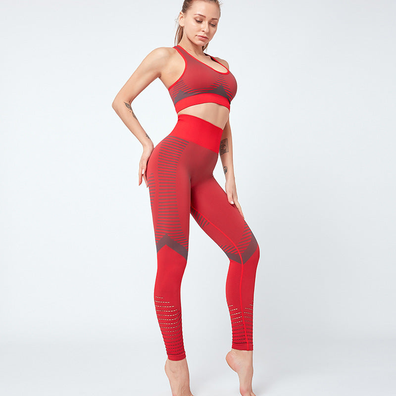 Woman wearing a red athletic outfit on a white background