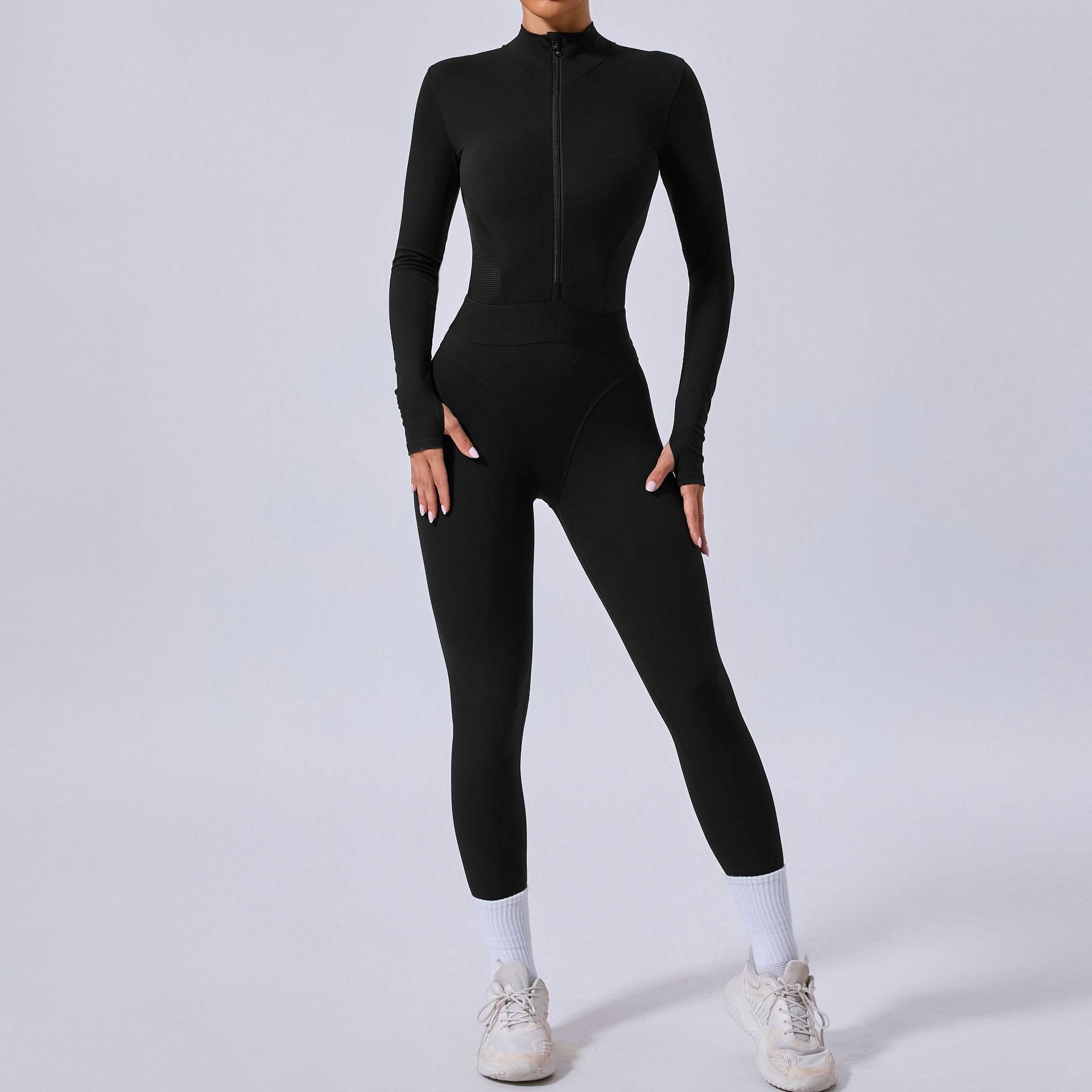 Person wearing a black full-body suit on a white background
