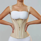 Woman wearing a beige waist trainer on a plain background