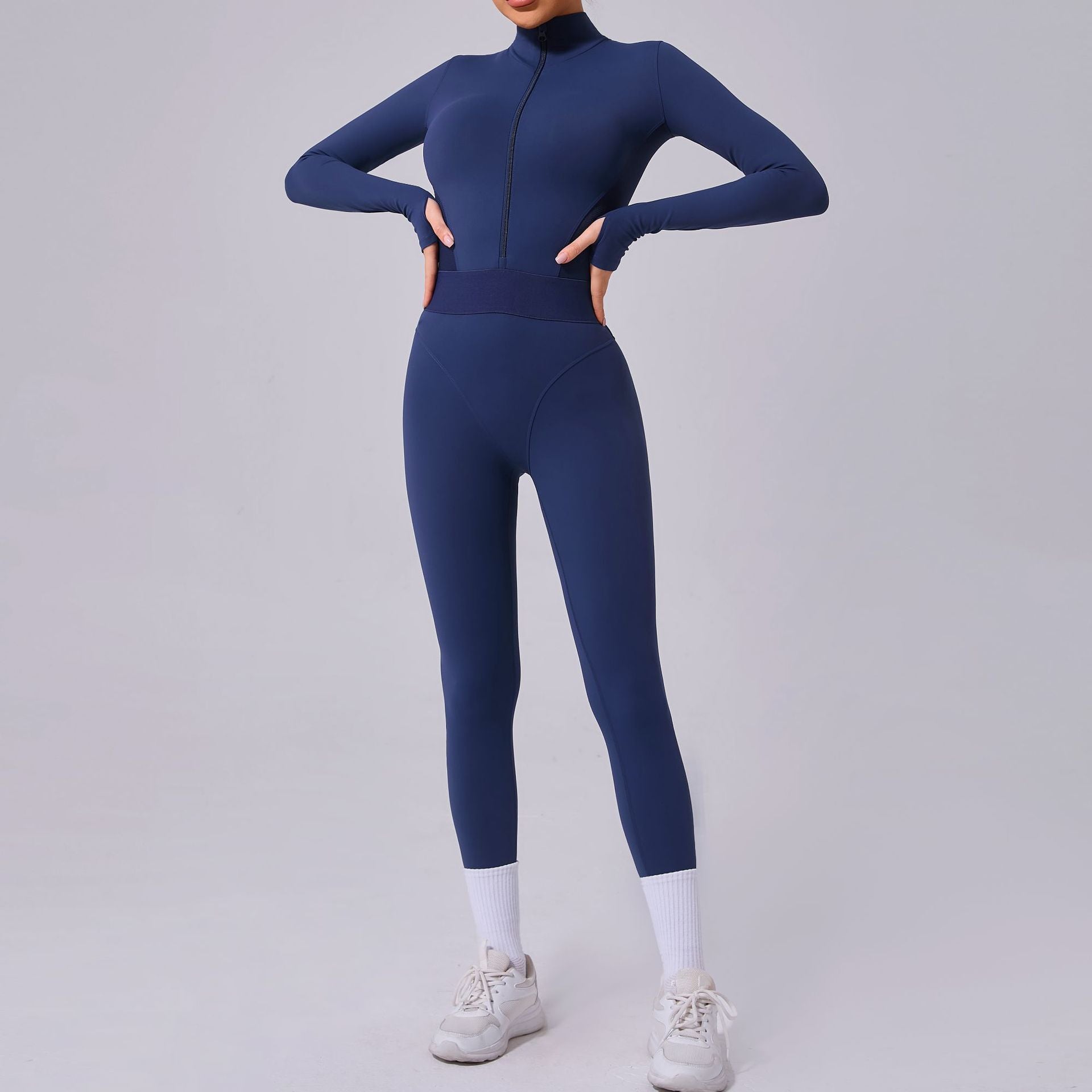 Person wearing a blue bodysuit on a gray background