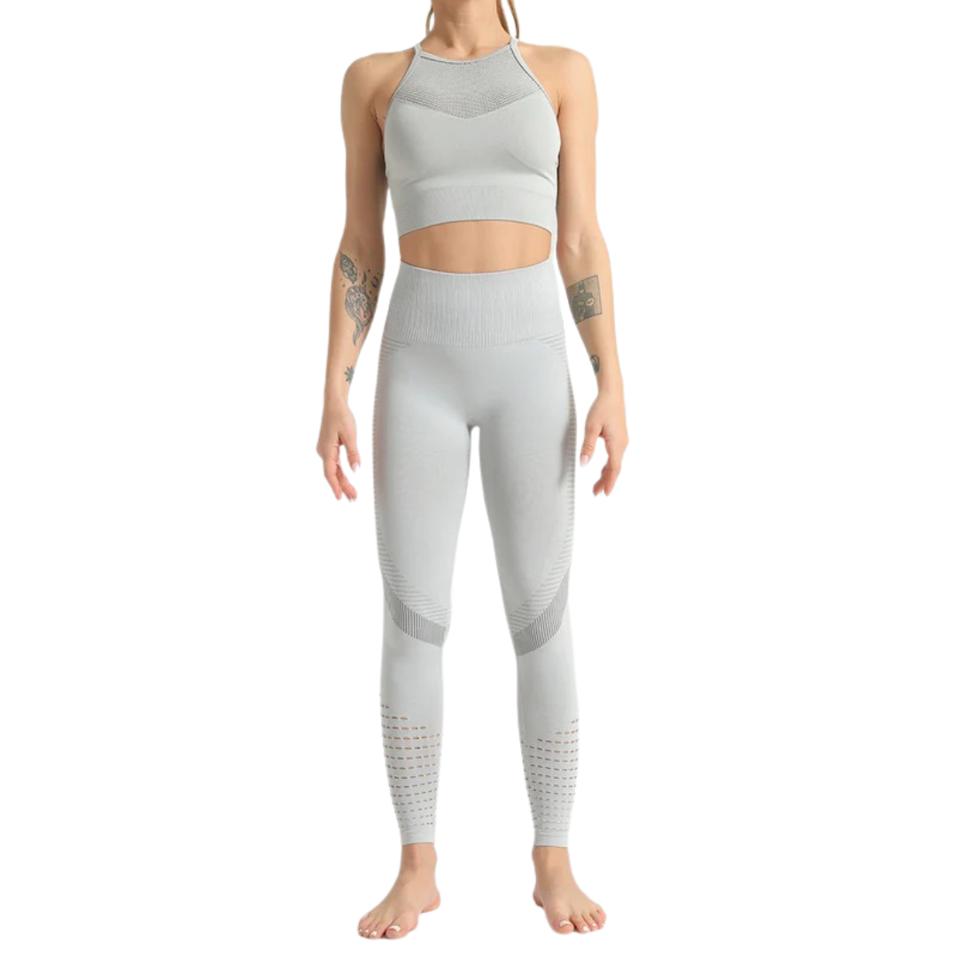 Person wearing a gray athletic outfit on a white background