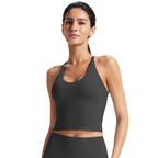 Woman wearing a black sports bra and leggings on a white background