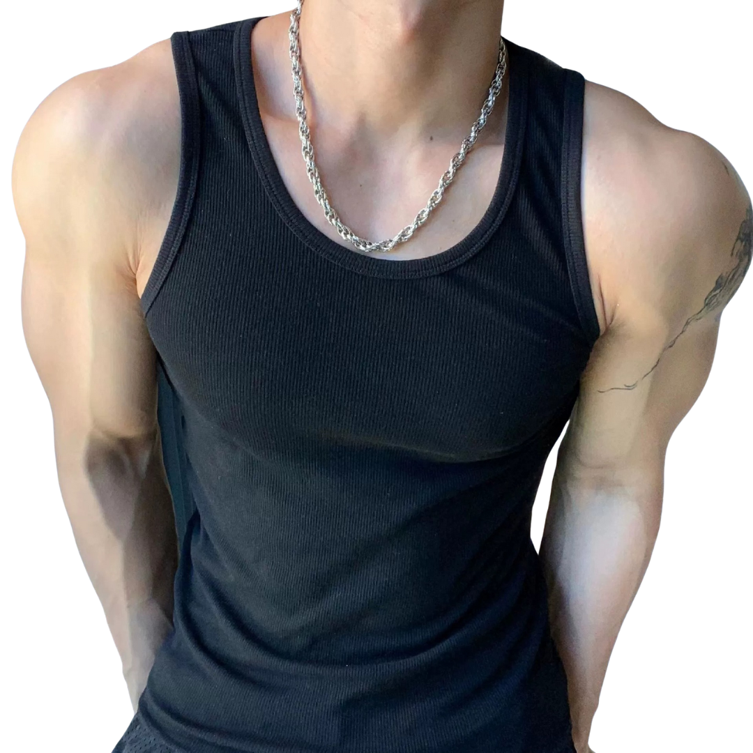 Person wearing a black tank top with visible tattoos on arms and chest.