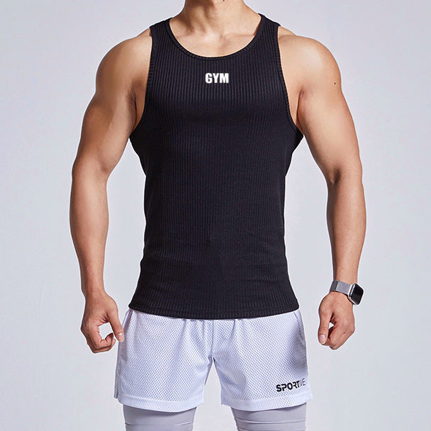 Person wearing a black 'GYM' tank top and white shorts on a light gray background