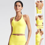 Woman wearing a yellow sports bra and leggings set on a light gray background