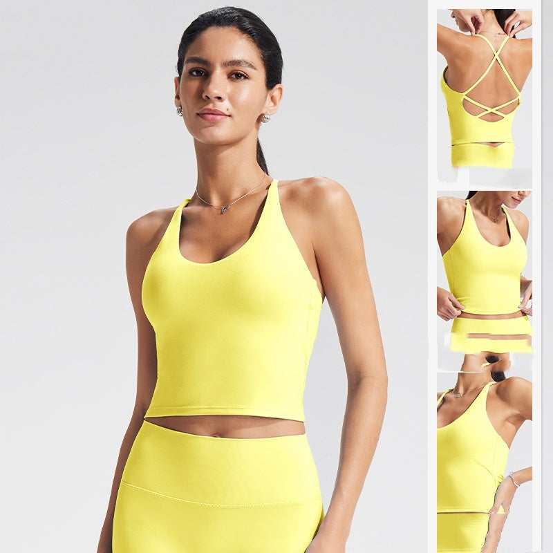 Woman wearing a yellow sports bra and leggings set on a light gray background