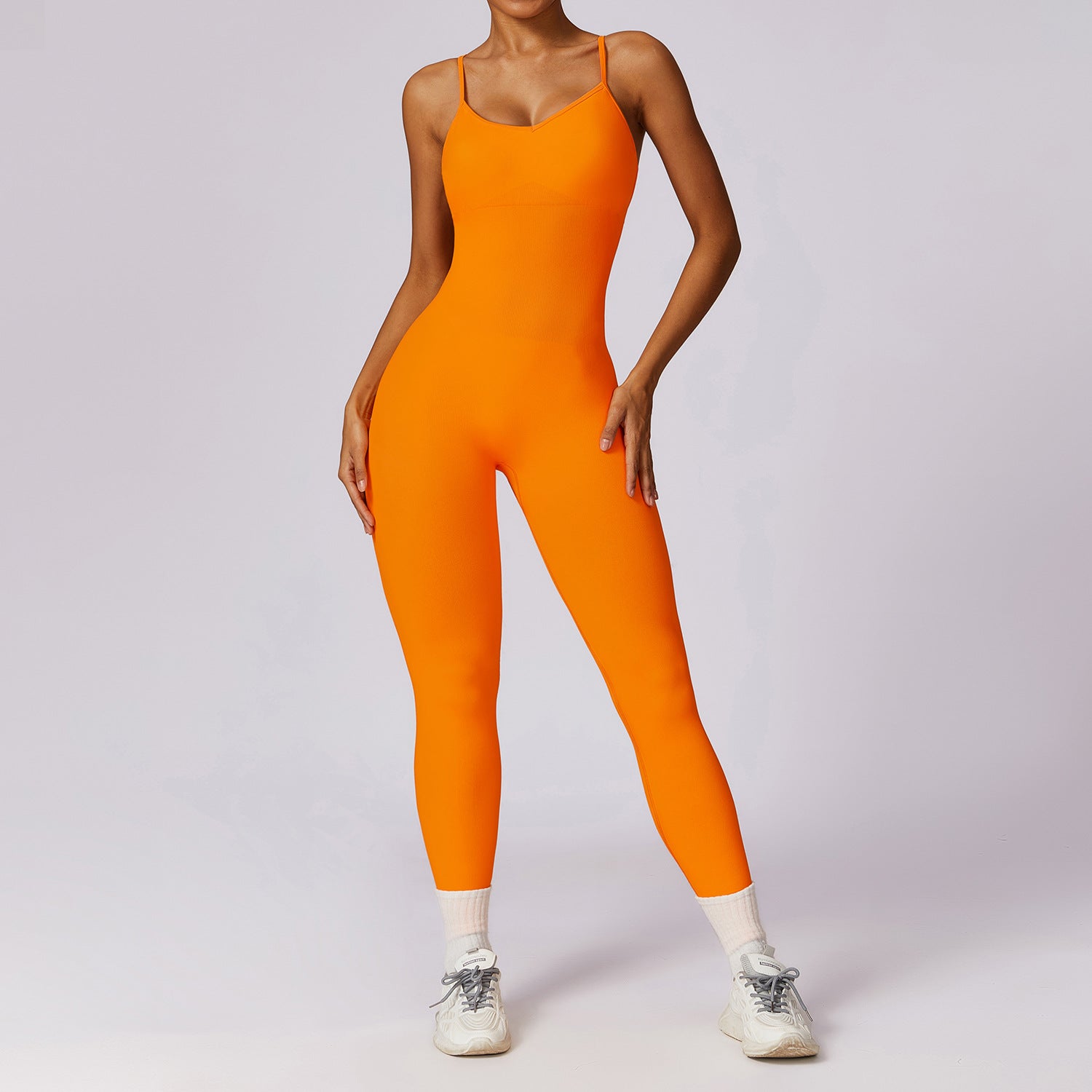 Person wearing an orange jumpsuit on a plain background