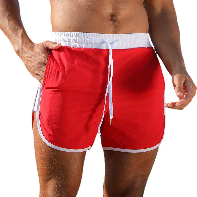 Red swim shorts with white trim on a white background