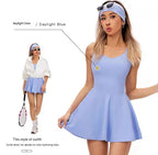 Woman wearing a light blue tennis dress with a white jacket and skirt, holding a tennis racket.